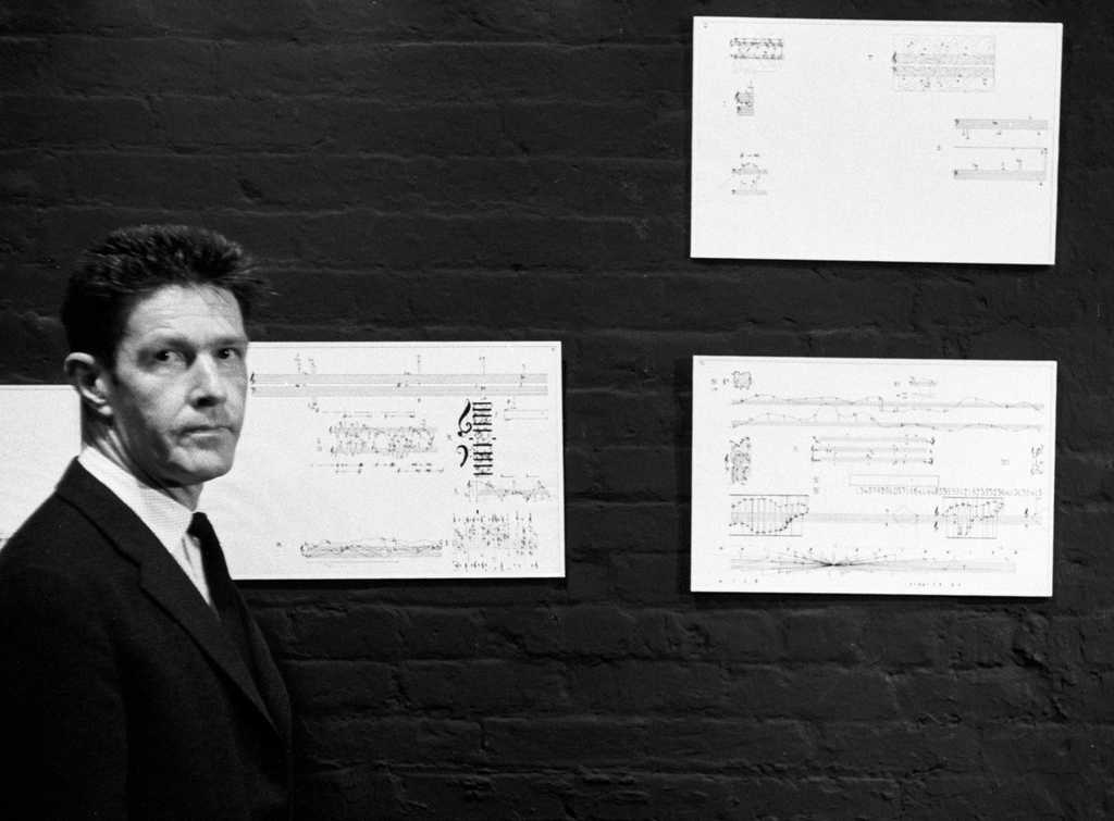 John Cage with pages from the Solo for Piano